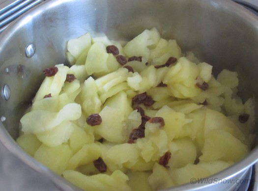 Cook apples and raisons for a few minutes until soft.