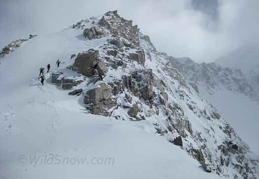 The boys on the ridge cramponing the wild snow.