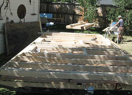 Without a large flat deck to work on (the wheels protrude), squaring and sheathing the walls reguired some extra work, but turned out fine. Scott and I found the side walls were too heavy for a quick lift so we had to do some Egyptian engineering to get them up.