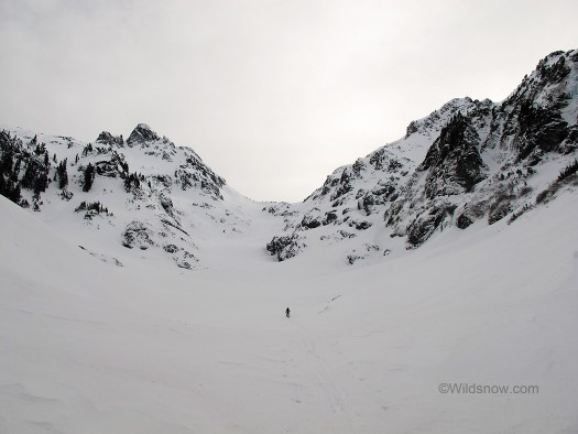 Into the valley of the shadow of snow; Skyler skinning below Goat Peak.