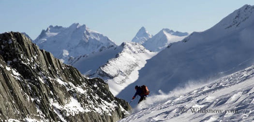 Sharon skiing off the Iconoclast Glacier. In the background are the Nordic peaks and the Nordic Glacier