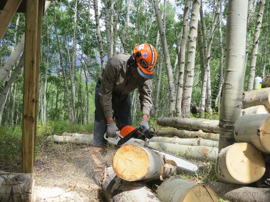 Cutting logs to fit. 14 inches is the perfect size for the cabin's small woodstove.