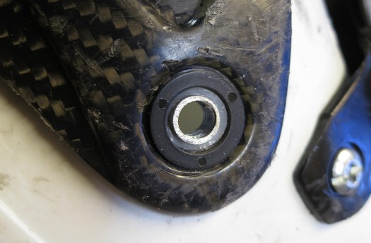 Black nylon washer/bushing in place, centered by virtue of the white nylon bushing protruding slightly above the boot cuff surface.