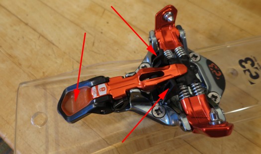Another view of toe unit. Left arrow points to a nice PU pocket for your ski pole tip. No more shattered plastic?