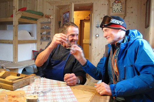 Wilfried's father toasts Lou with a glass of homemade schnapps.