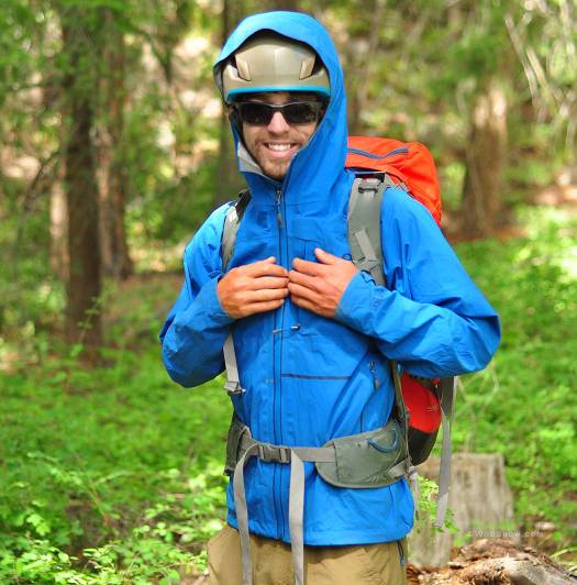 OR Axiom features a hood big enough to fit over a helmet, and pockets that remain accessible with a pack or harness on.