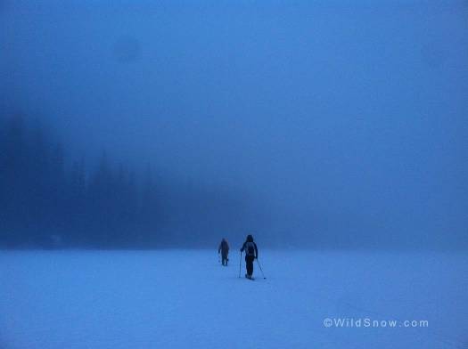 Crossing a frozen Lake Julius at twilight in the eerie mist. Photo by Noah Young.