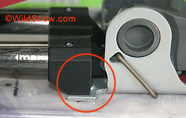Heel unit is located such that rear of carbon fiber rails is close to rear of screw in base plate. 