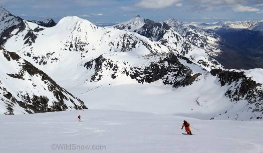 Two old masters, Endre (orange) and Lou head down the vast summit snowfield.