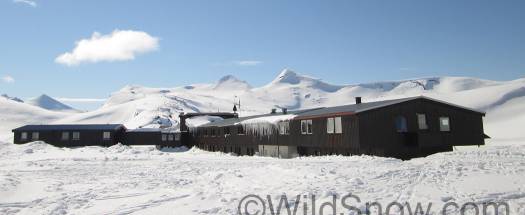 Another view of the lodge with mountains everywhere asking to be skied.