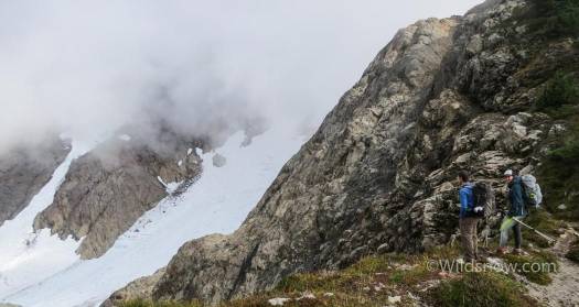 Checking out a brief view on our way up. The lookout is on top of the rocky peak past the glacier, hidden by clouds.