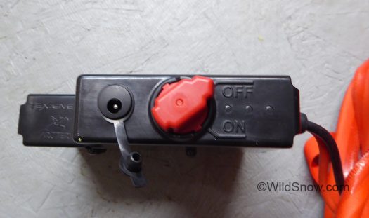Red  battery on-off switch , with charger port to left.