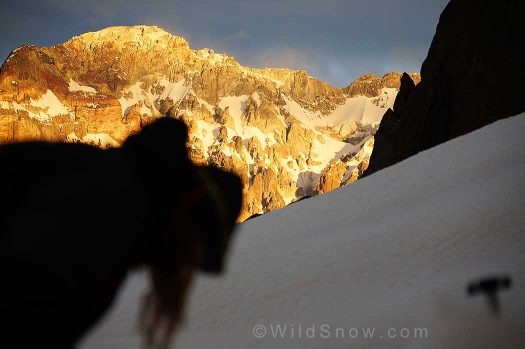 Sole preps her pack for the next day while the last rays of sun illuminate Cerro Marmolejo's west wall.