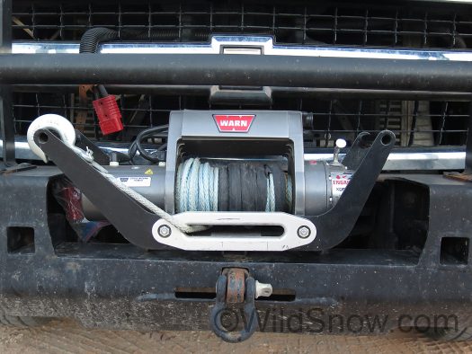 Warn winch mounts on a customized 2 inch receiver attached to our front bumper, it easily comes off and mounts on rear trailer hitch so we can recover backwards.