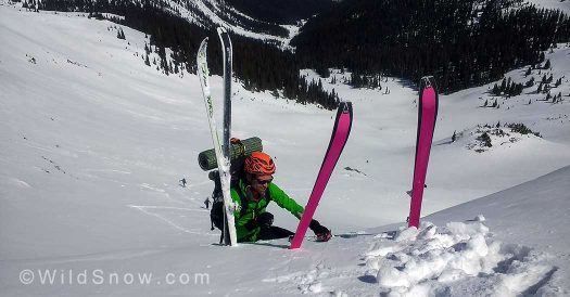 Using skis as handholds pulling over the cornice on New York Pass heading to the Friends Hut and Crested Butte