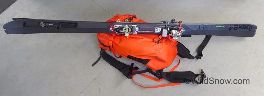 There is no dedicated diagonal ski carry system, but it's easily rigged with a few accessory straps.