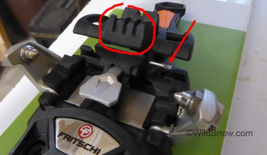 Removing the boot toe bumper (circled) requires removing a pin (arrow).