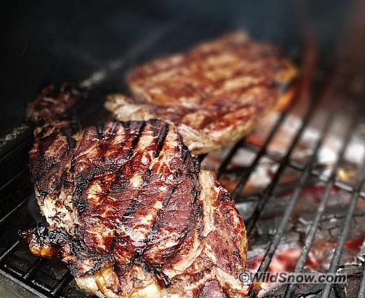 Beef ribeye steaks over a wood fire are also tasty. Photo by Aaron Schorsch.