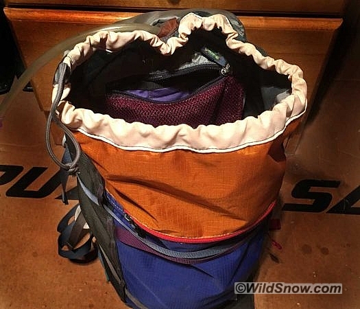 A zippered mesh pocket inside the main compartment acts as the cover flap for the hydration sleeve, and provides storage space for snacks or tools. A sleeve is provided for a hydration bladder, but there is no insulation for the hose.  I used an Osprey bladder with a formed reservoir to give the pack enough shape and support to stand up more readily while accessing the main compartment. Using a simple slit-style bite valve avoided some of the freezing issues that beset more complicated on-off valves.