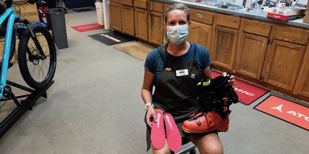 Sam pictured here with her masterpieces: handcrafted footbeds, heat molded liners, and her big [behind the mask] smile.