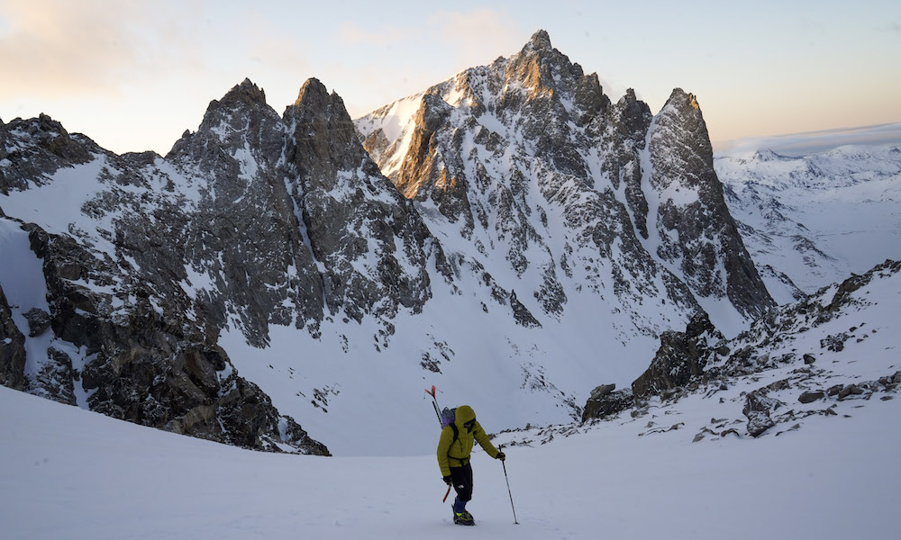 Gavin on the bootpack to the saddle with the first rays of morning light behind him. (Photo: @morgankelsey)