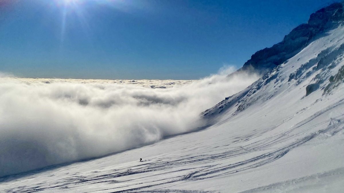 Louie skiing in the distance right below camp Muir, cloud incoming…!