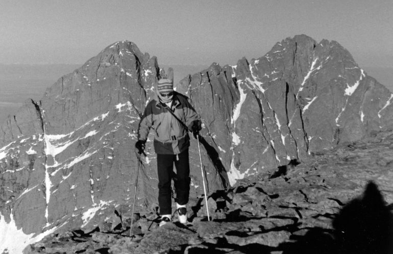 He's got the boots, but where are the planks? On  Humboldt Peak looking at Crestone Needle and Peak.