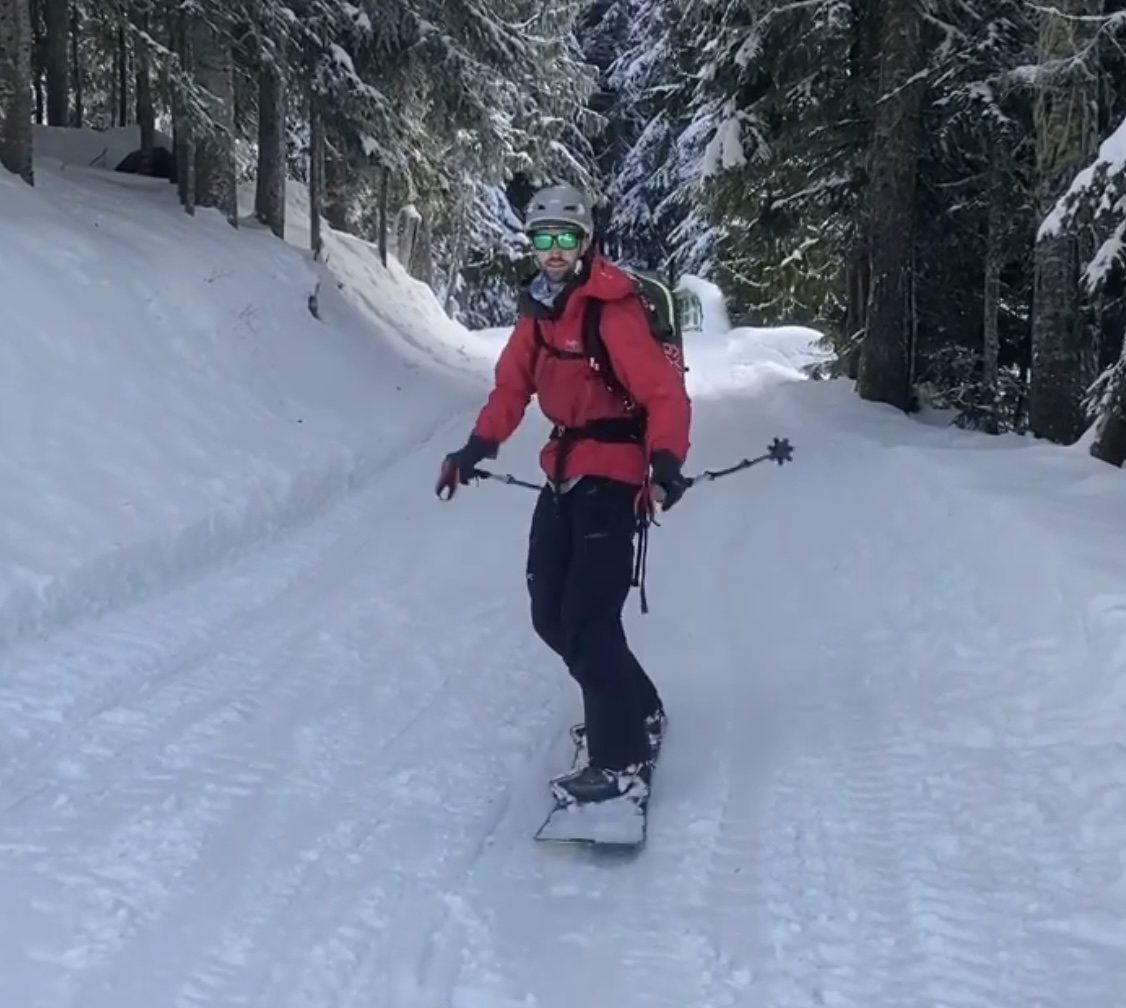 Pole pushing on a snowboard.