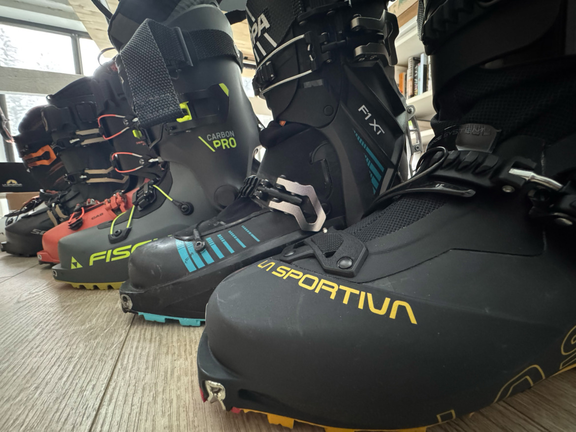 line up of backcountry ski boots in order of weight, descending with La Sportiva Kilo boot in the foreground