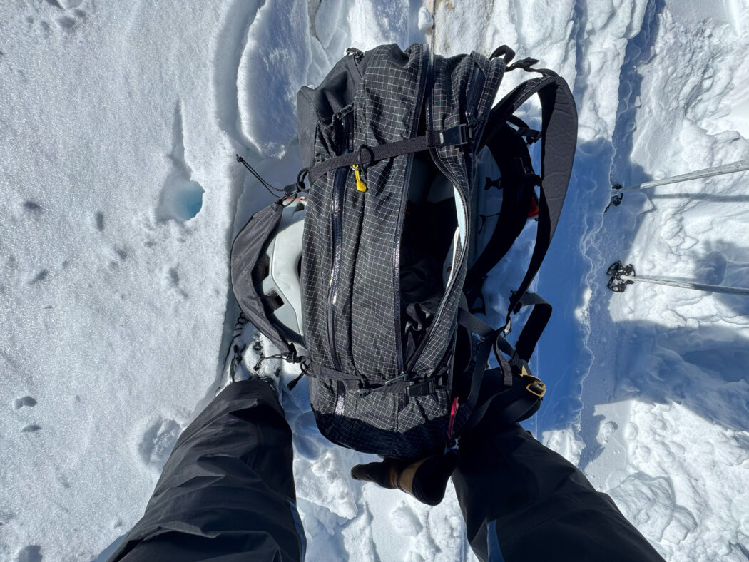 Arc'teryx Micon LiTRIC 42 pack on snow on top of skis