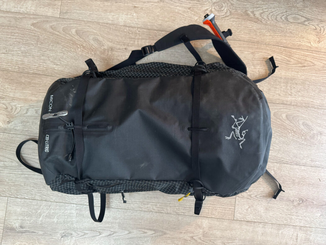 arcteryx micon litric 42 liter ski backpack on wood floor with back of pack facing up