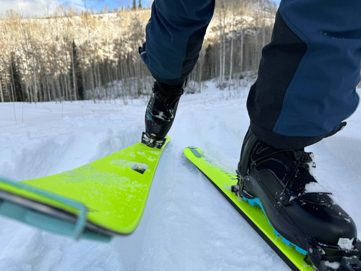 close up of skis touring uphill coming at the camera