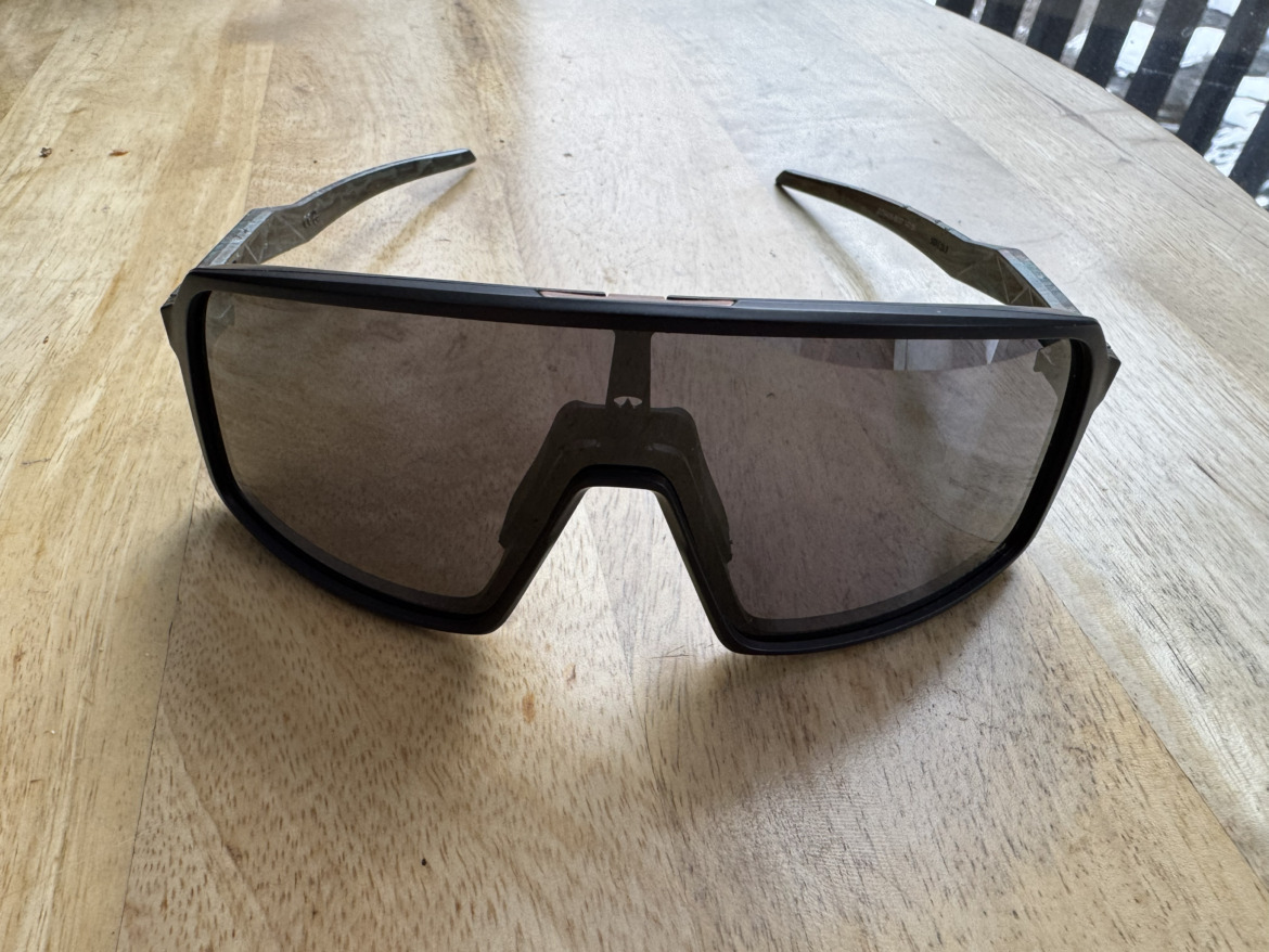 ski touring sunglasses sitting on a wood countertop