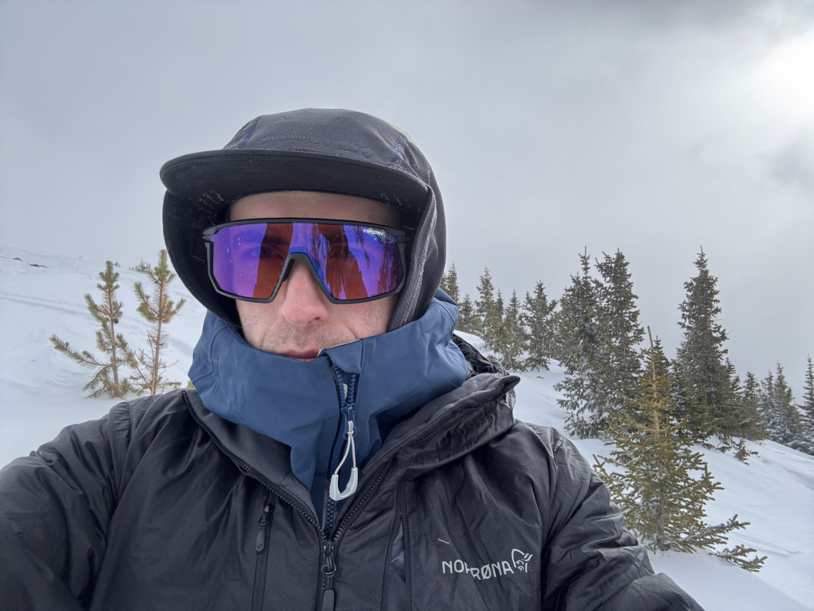 close-up selfie of skier in hat with hood up wearing Tifosi Moab sunglasses