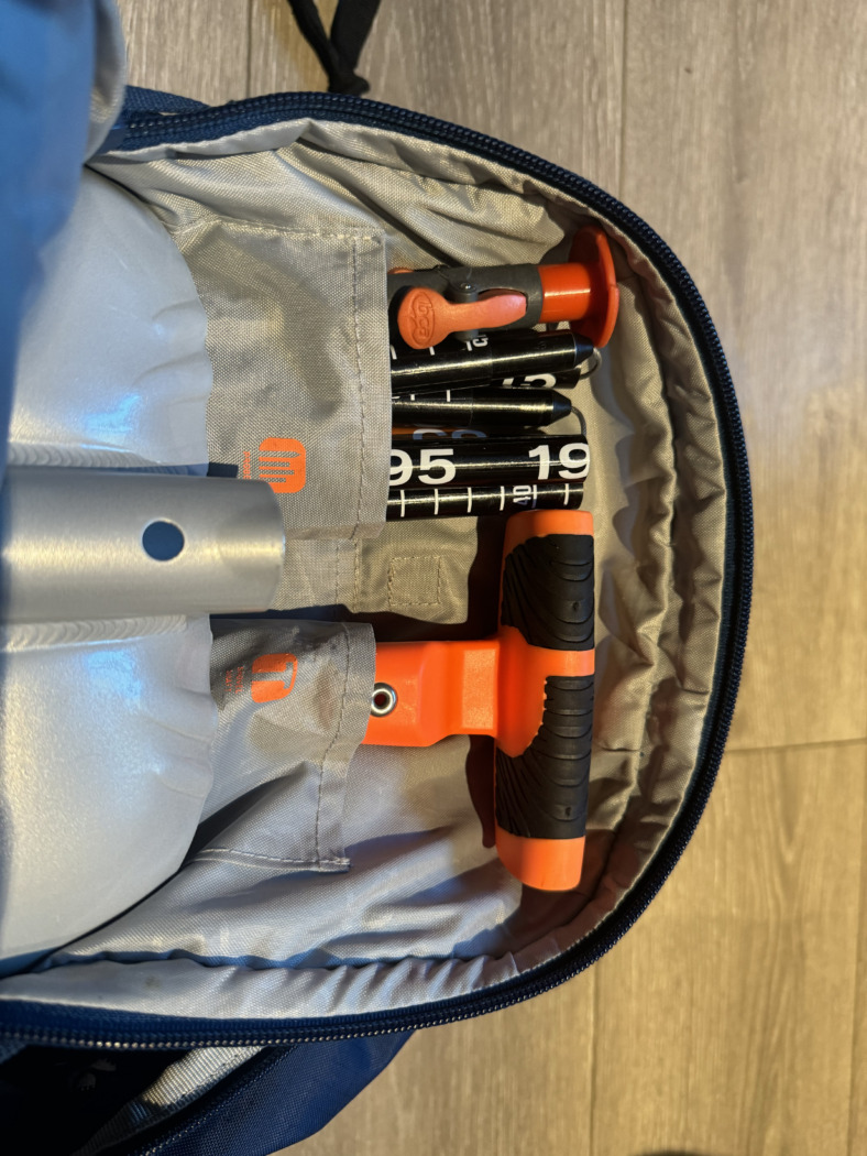 avalanche safety tools in a backpack