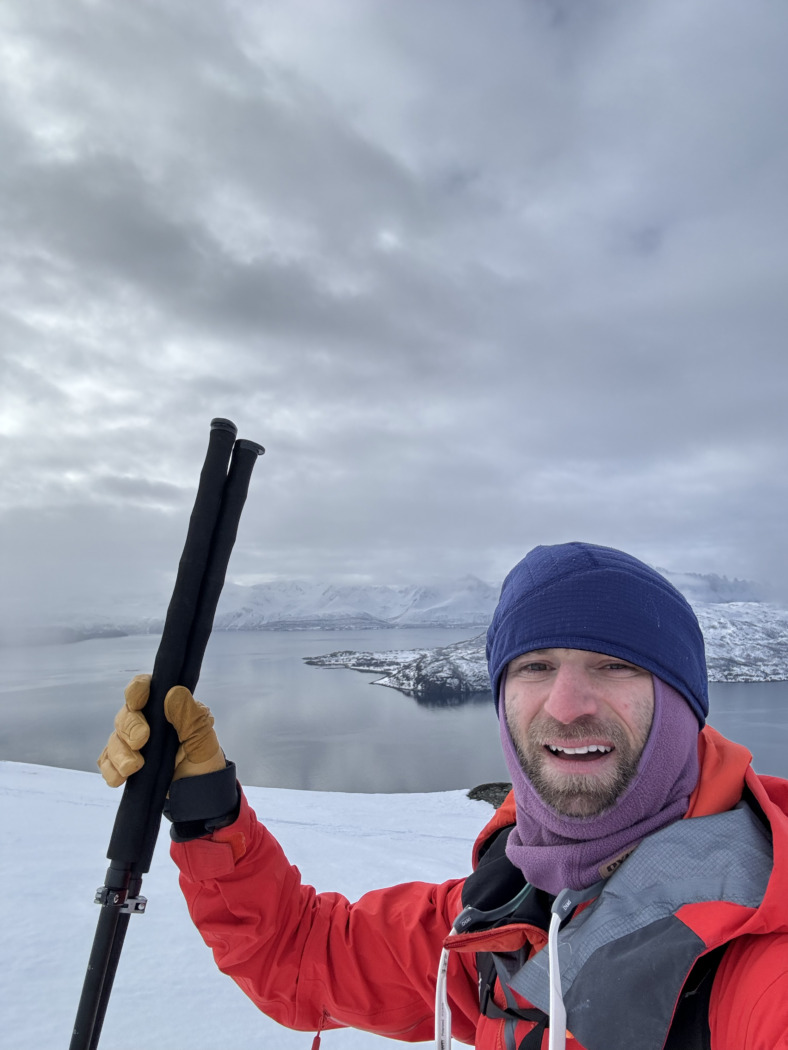 Author Drew Zieff holding Wolverine Split Sticks splitboarding poles in Norway on snow