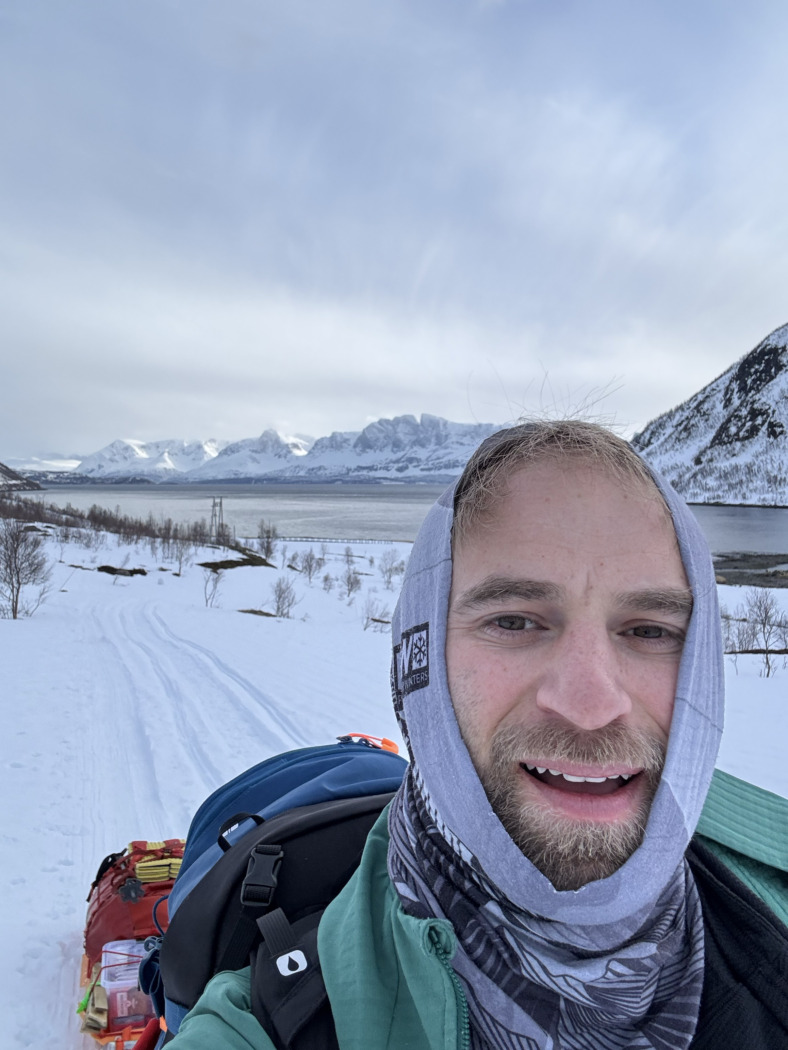 selfie of a man pulling a sled in the snow