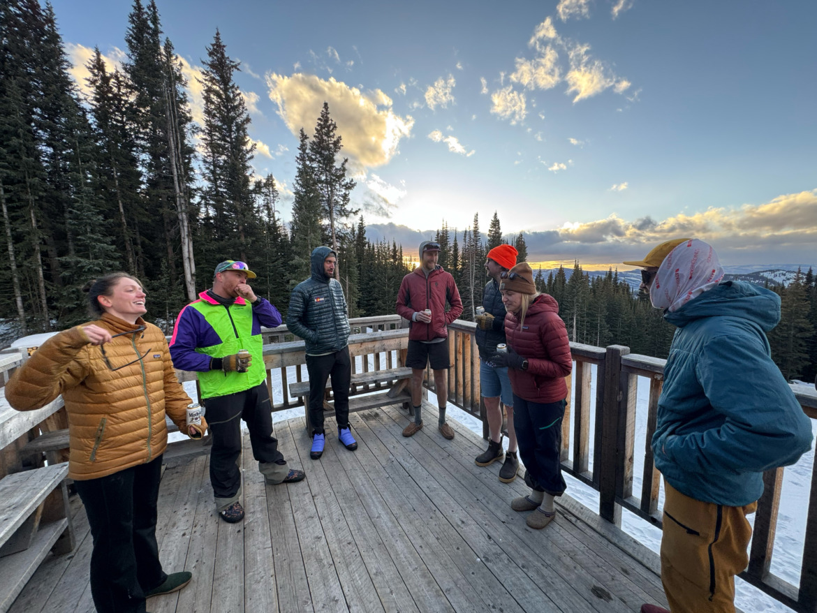 Skiers standing on the deck of a backcountry hut in Colorado